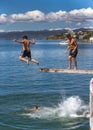 Teenagers jumping off diving board. Royalty Free Stock Photo