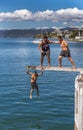 Teenagers jumping off diving board. Royalty Free Stock Photo