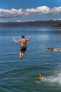 Teenagers jumping off diving board. Royalty Free Stock Photo