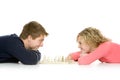 Teenagers lying down playing chess Royalty Free Stock Photo