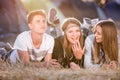 Teenagers lying on the ground in front of tents Royalty Free Stock Photo