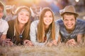 Teenagers lying on the ground in front of tents Royalty Free Stock Photo