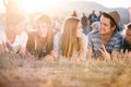 Teenagers lying on the ground in front of tents Royalty Free Stock Photo