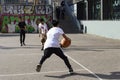 Teenagers play street basketball or streetball. Sports, healthy lifestyle and team games in the street of Barcelona