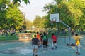 Teenagers playing basketball at City park