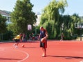 Teenagers playing basketball on playground Royalty Free Stock Photo