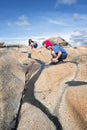 Teenagers playing with stream at the rock. Royalty Free Stock Photo