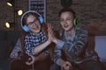 Teenagers playing video games at home late in the evening Royalty Free Stock Photo