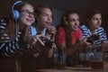 Teenagers playing video games at home late in the evening Royalty Free Stock Photo