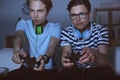 Teenagers playing video games at home late in the evening Royalty Free Stock Photo