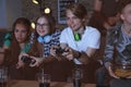 Teenagers playing video games at home late in the evening Royalty Free Stock Photo