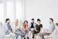 Teenagers during psychotherapy with professional counselor , copy space on empty white wall
