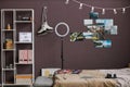 Teenagers room interior with hobbie items on maroon wall Royalty Free Stock Photo