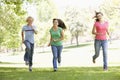 Teenagers Running Through Park Royalty Free Stock Photo