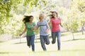 Teenagers Running Through Park Royalty Free Stock Photo