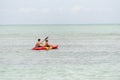 Teenagers at sea with a canoe Royalty Free Stock Photo