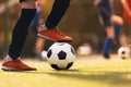 Teenagers on sports training. The player kicking a classic soccer ball. Group of youth soccer players playing with balls on a Royalty Free Stock Photo