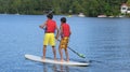 Teenagers on a Stand up Paddle Board on a Lake Royalty Free Stock Photo