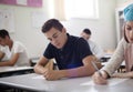 Teenagers students sitting in the classroom and writing Royalty Free Stock Photo