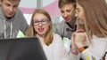 Teenagers studying together at school library, using laptop Royalty Free Stock Photo