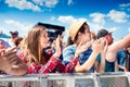 Teenagers at summer music festival clapping and singing