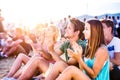 Teenagers at summer music festival, sitting on the ground Royalty Free Stock Photo