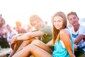 Teenagers at summer music festival, sitting on the ground Royalty Free Stock Photo