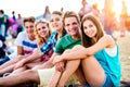 Teenagers at summer music festival, sitting on the ground Royalty Free Stock Photo