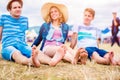 Teenagers at summer music festival, sitting on the ground Royalty Free Stock Photo