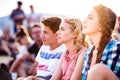 Teenagers at summer music festival, sitting on the ground Royalty Free Stock Photo