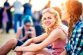 Teenagers at summer music festival, sitting on the ground Royalty Free Stock Photo