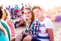 Teenagers at summer music festival, sitting on the ground Royalty Free Stock Photo