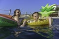 Teenagers in Swimming Pool in inflatables Royalty Free Stock Photo