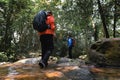 Teenagers trekking competition to collect ribbons at each checkpoint in the forest.