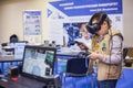 Teenagers using virtual reality headset at technology show