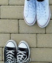 Teenagers with white and black sneakers, top view
