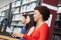 Teenagers working on computers in library