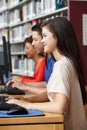 Teenagers working on computers in library Royalty Free Stock Photo