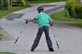 Teenages skating on the street wearing a helmet