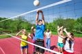 Teens all are with arms up play volleyball