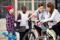 Teens chatting near bikes Royalty Free Stock Photo