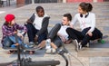 Teens chatting near bikes