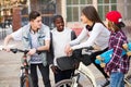 Teens chatting near bikes Royalty Free Stock Photo