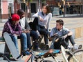 Teens chatting near bikes