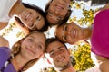 Teens in a circle smiling in park