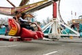 Teens Enjoy Fast Moving Carnival Ride At Fair