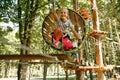 Teens in equipment climbs in rope park, playground Royalty Free Stock Photo