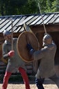 Teens fighting with swords in medieval dress