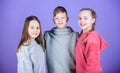 Teens friends. Girl and boy true friendship. Children smiling faces on violet background. Friends hug. Cheerful youth