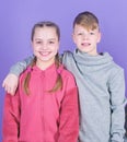 Teens friends. Girl and boy true friendship. Children smiling faces on violet background. Friends hug. Childrens day